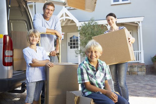 Movers loading furniture into a van on a Fulham residential street