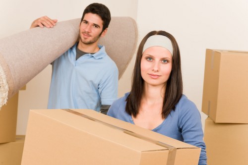 Professional movers carrying furniture during a Fulham move