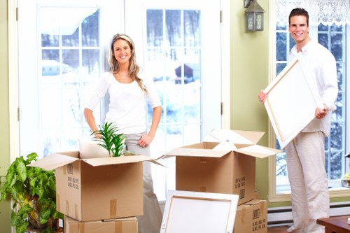Specialist movers navigating a piano through a narrow Fulham property